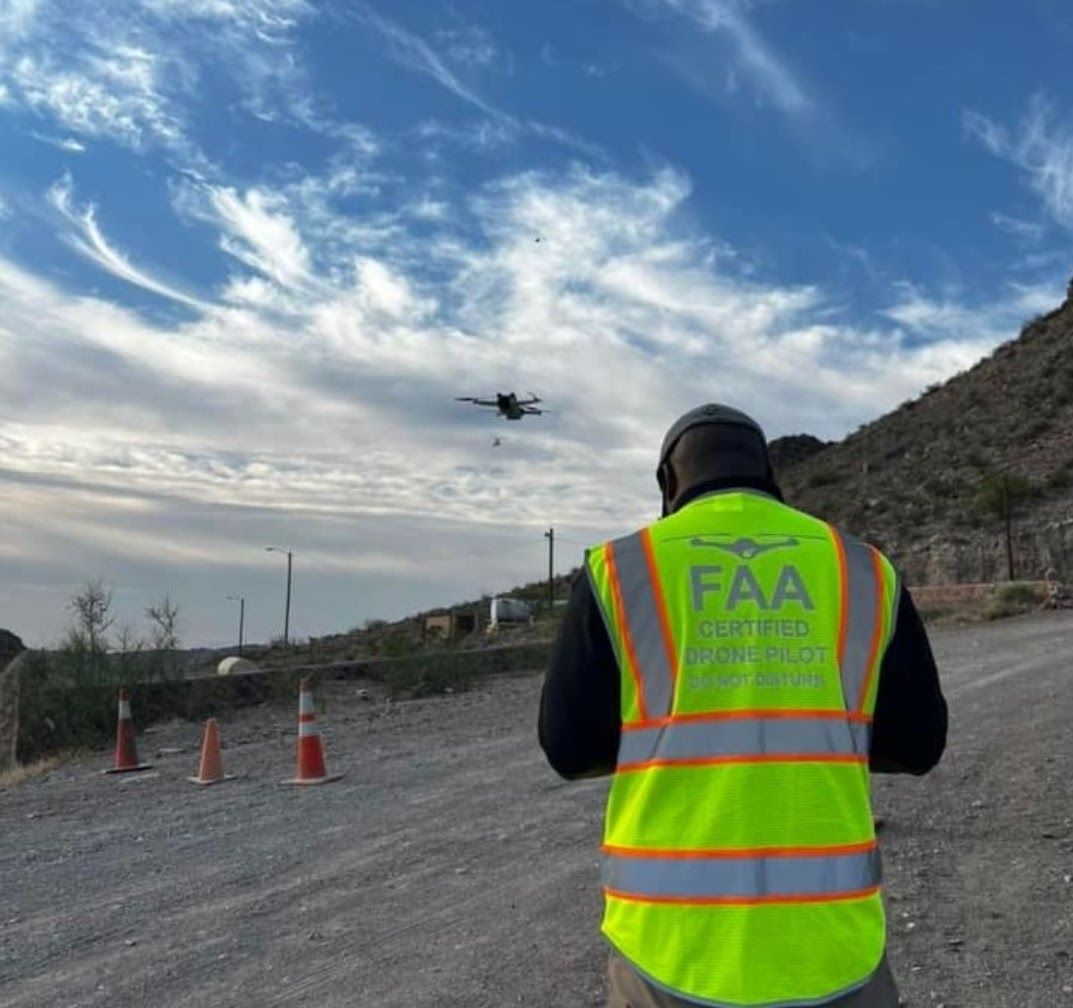 FAA Licensed Drone Pilot: An image portraying an individual holding an FAA (Federal Aviation Administration) drone pilot license or certificate. The person might be displaying the official document or identification card issued by the FAA, indicating their authorization to operate drones for commercial or recreational purposes. This highlights the pilot's compliance with aviation regulations and qualifications in drone piloting.