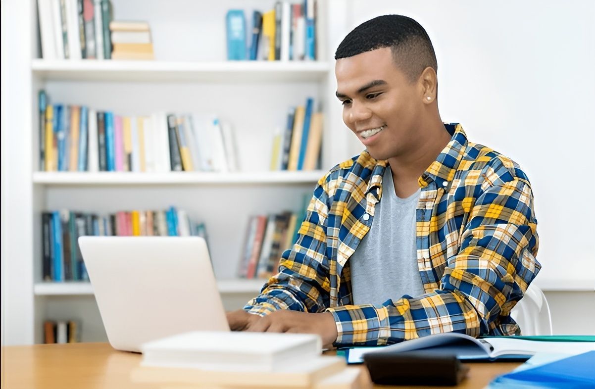 El Paso student working on a laptop for computer science coursework.