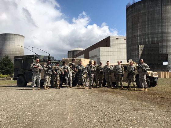 Military personnel coordinating emergency response efforts on the ground.