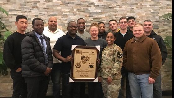 Group at Military Award Presentation: A gathering of individuals at a military award presentation ceremony.