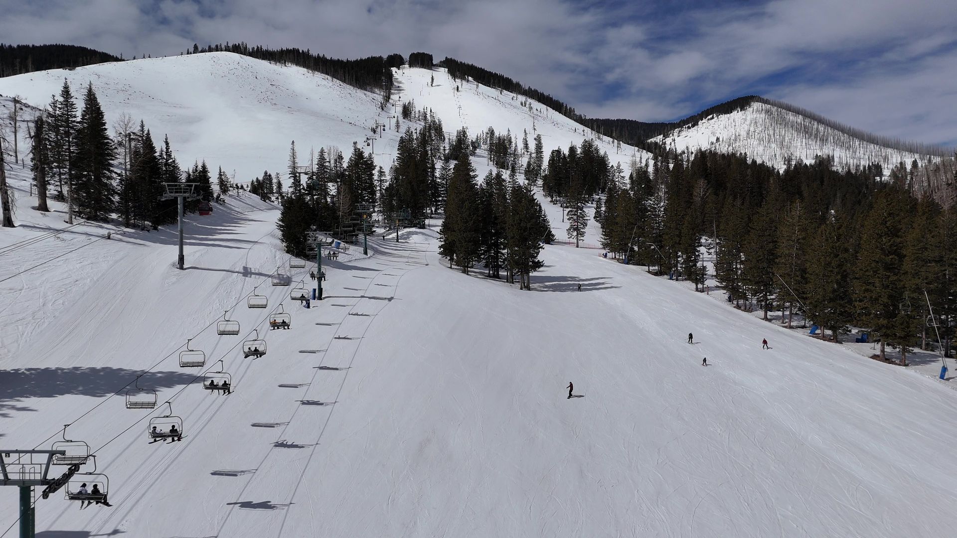 Drone shot of Ski Apache Resort in New Mexico, featuring snow-covered slopes and ski lifts against a mountain backdrop.