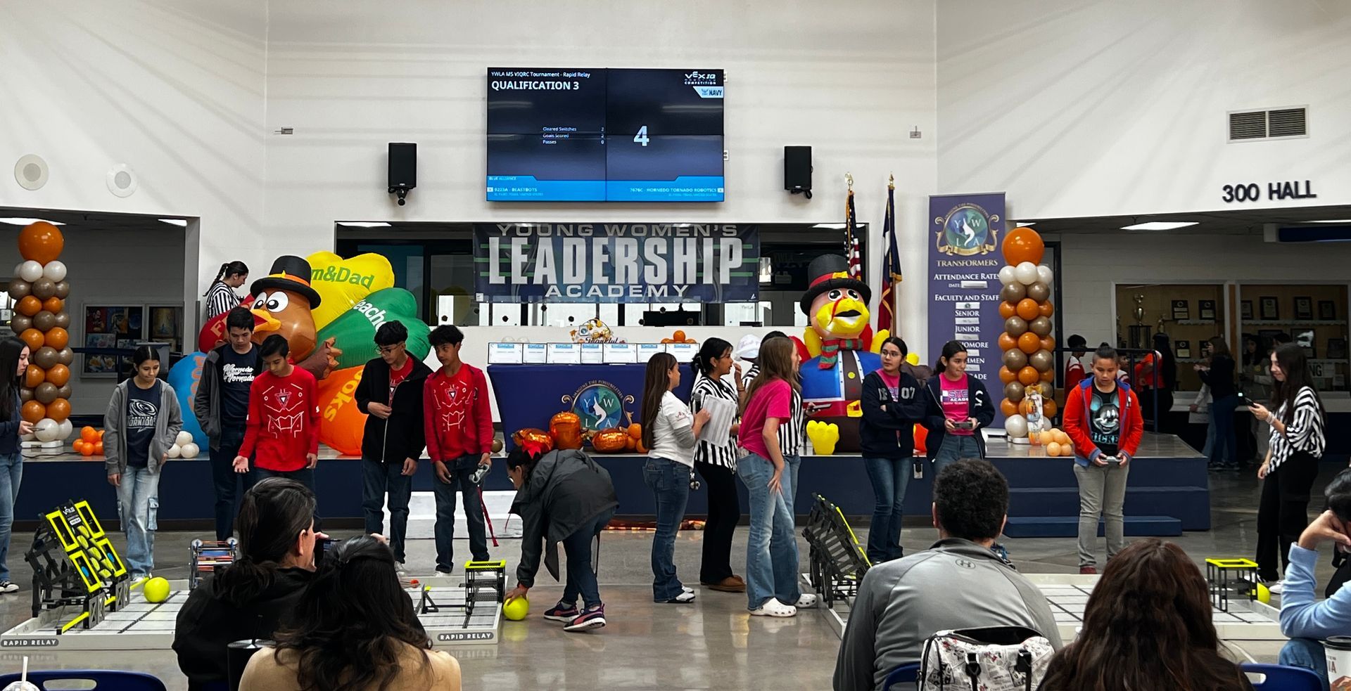 VEX IQ Robotics Tournament finals at Young Women's Leadership Academy, El Paso, Texas, teams discussing strategy.
