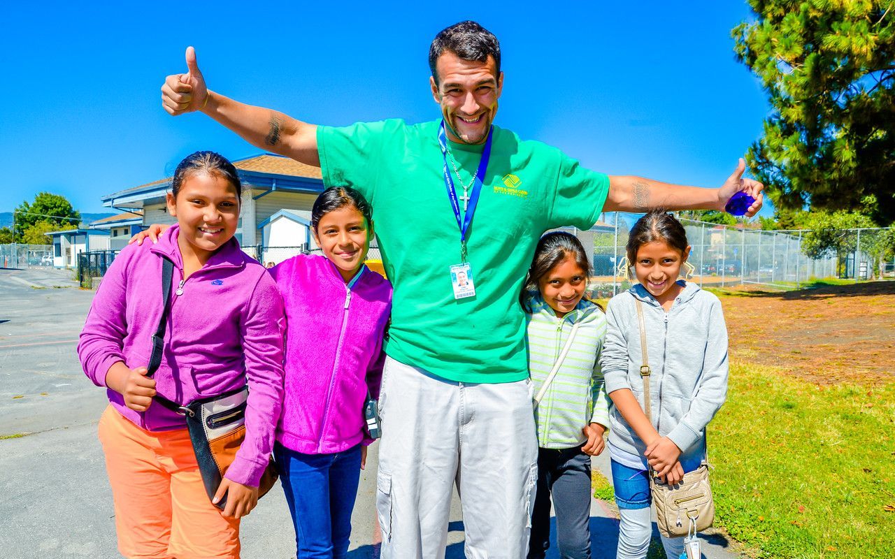 A volunteer interacting with kids at the Boys & Girls Club of El Paso.