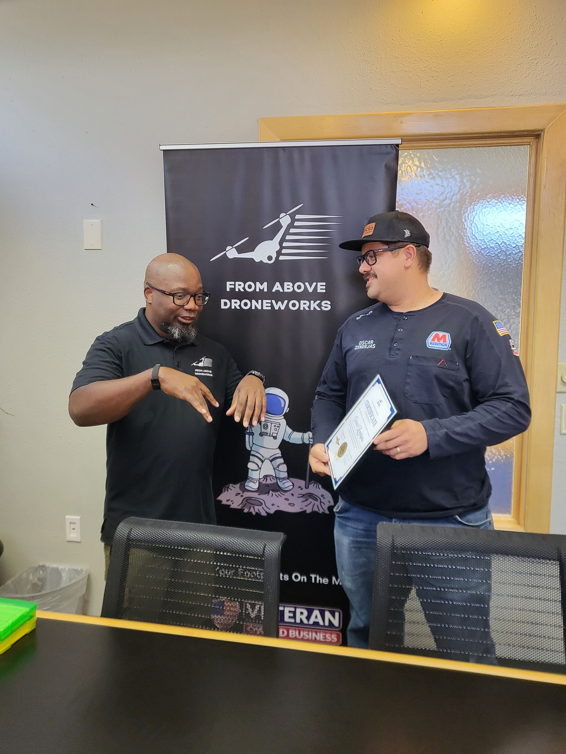 Baby Rain completing FAA Part 107 training with certificate and badge