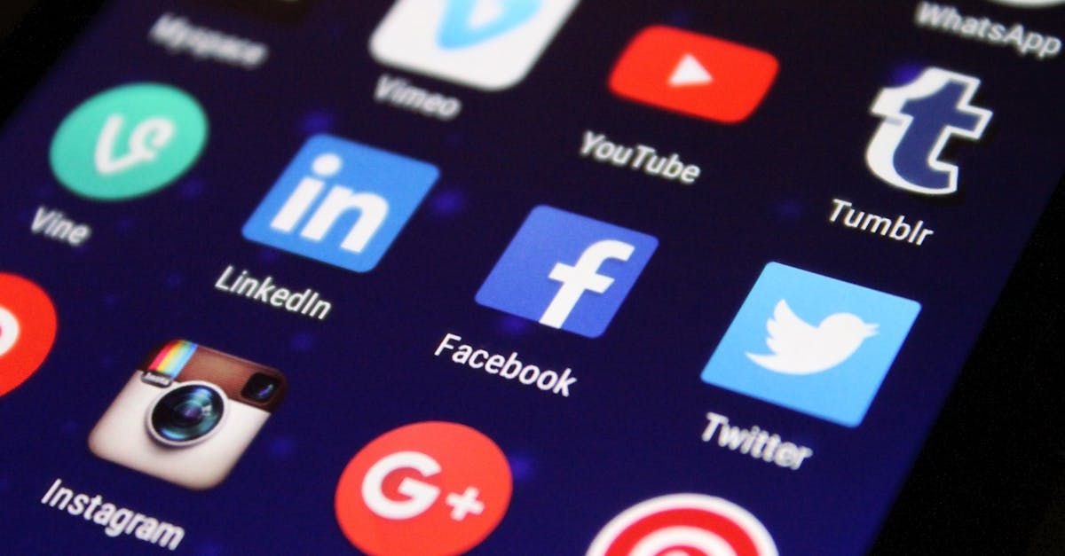 Icons for Facebook, Instagram, Twitter, and LinkedIn on a desk with a pen, notebook, and coffee in El Paso, TX