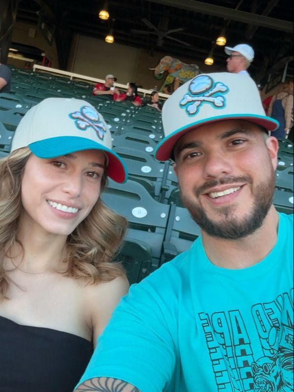Smiling veteran family in Chihuahuas gear at Southwest University Park El Paso.