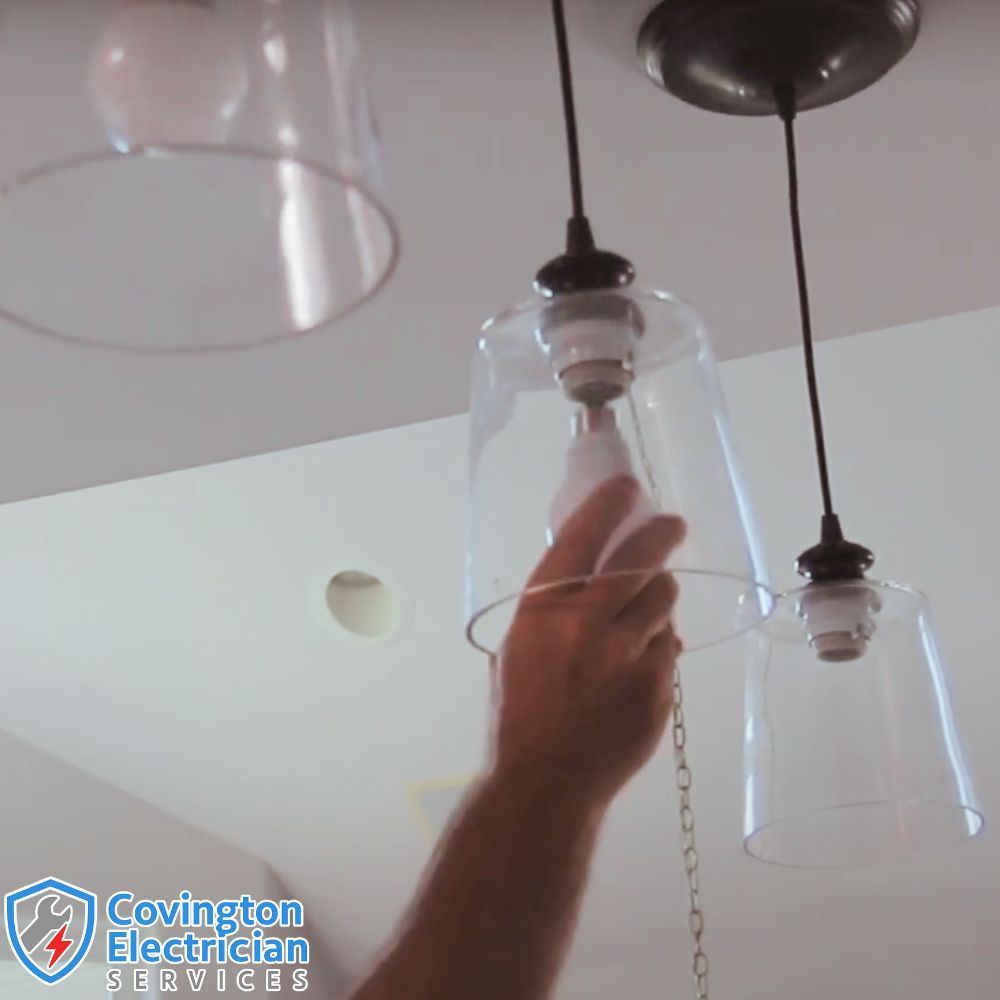 Licensed Electrician installing a ceiling light fixture in a residential home in Covington, KY