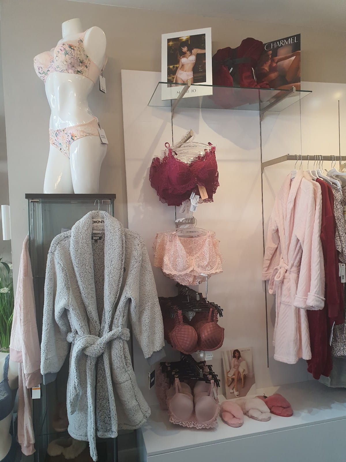 A store filled with lots of clothes and a mannequin.