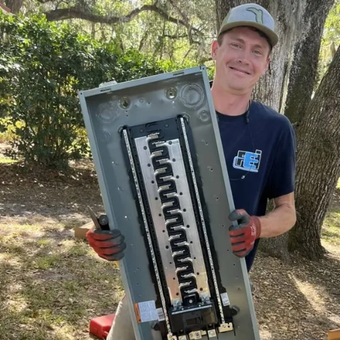 Faulkner Electric Employee holding Electrical Panel