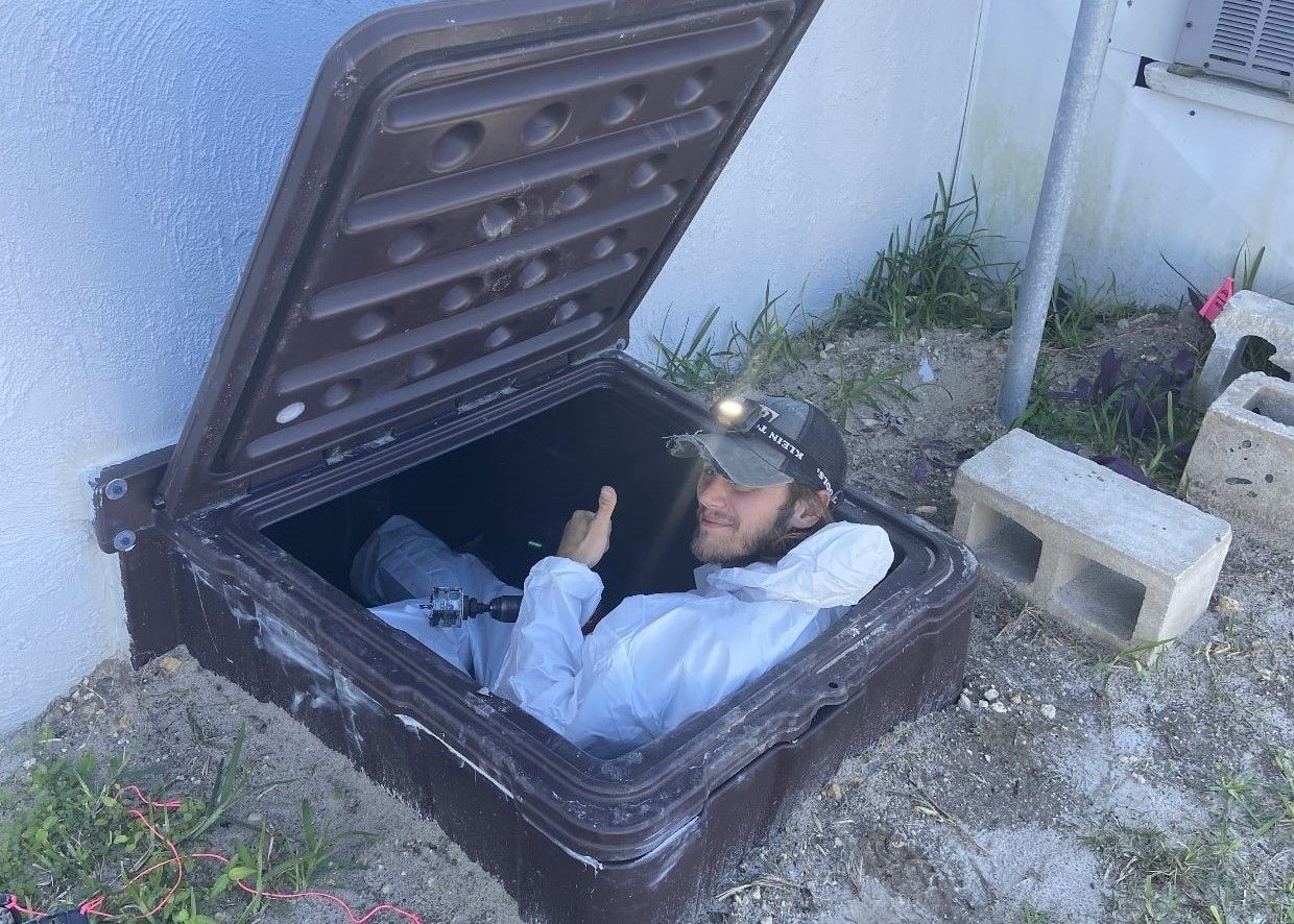 A man is sticking his head out of a hole in the ground.