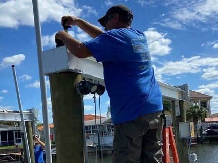 A man in a blue shirt is working on a dock.