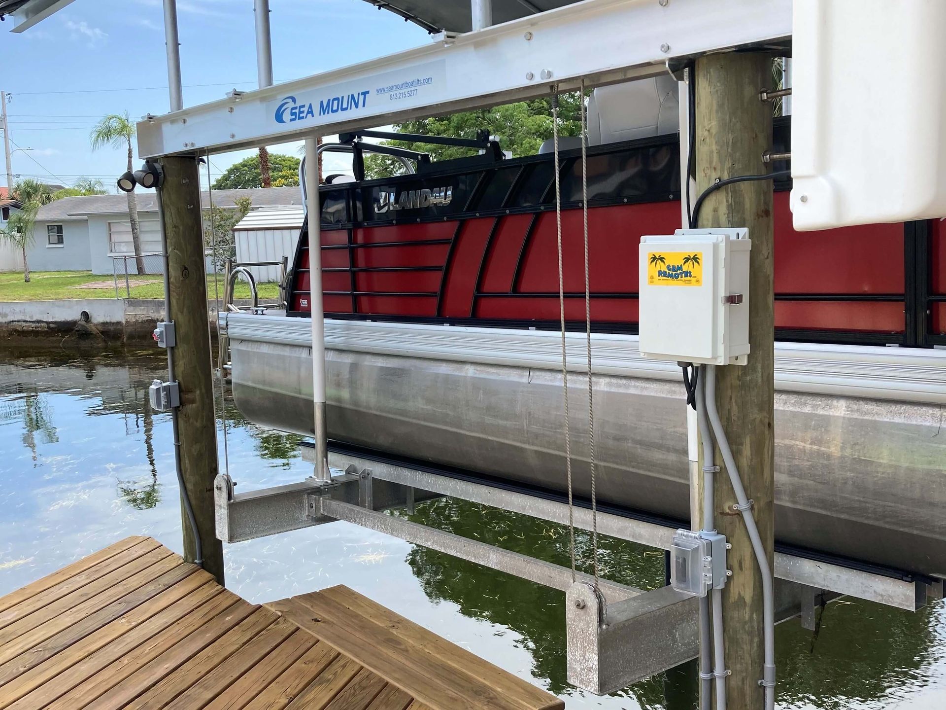 A boat is being lifted into a dock by a dock lift.