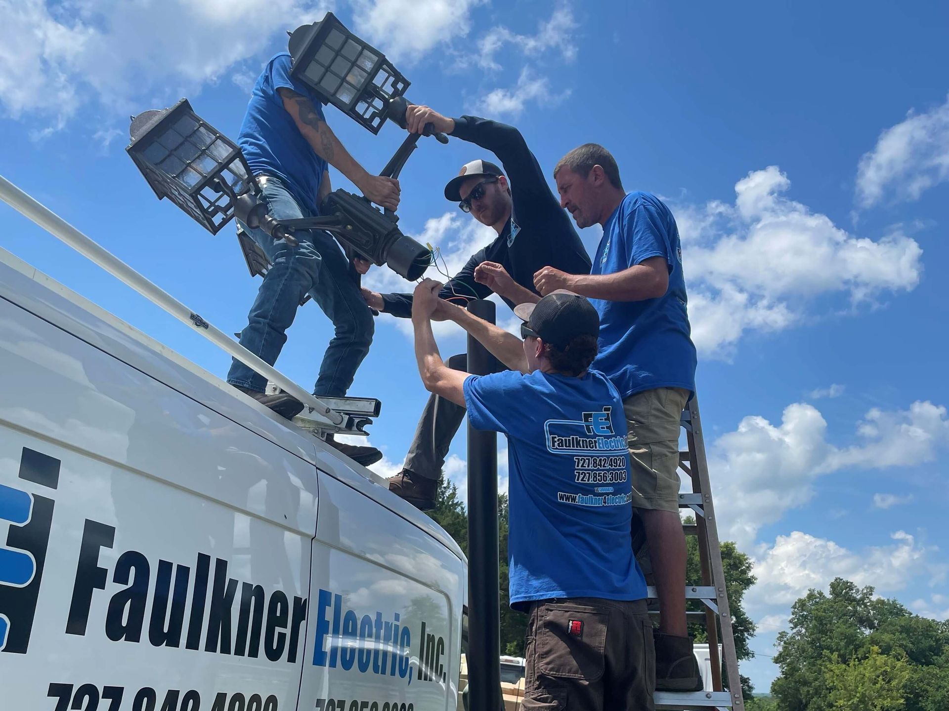 A group of men are working on a van.