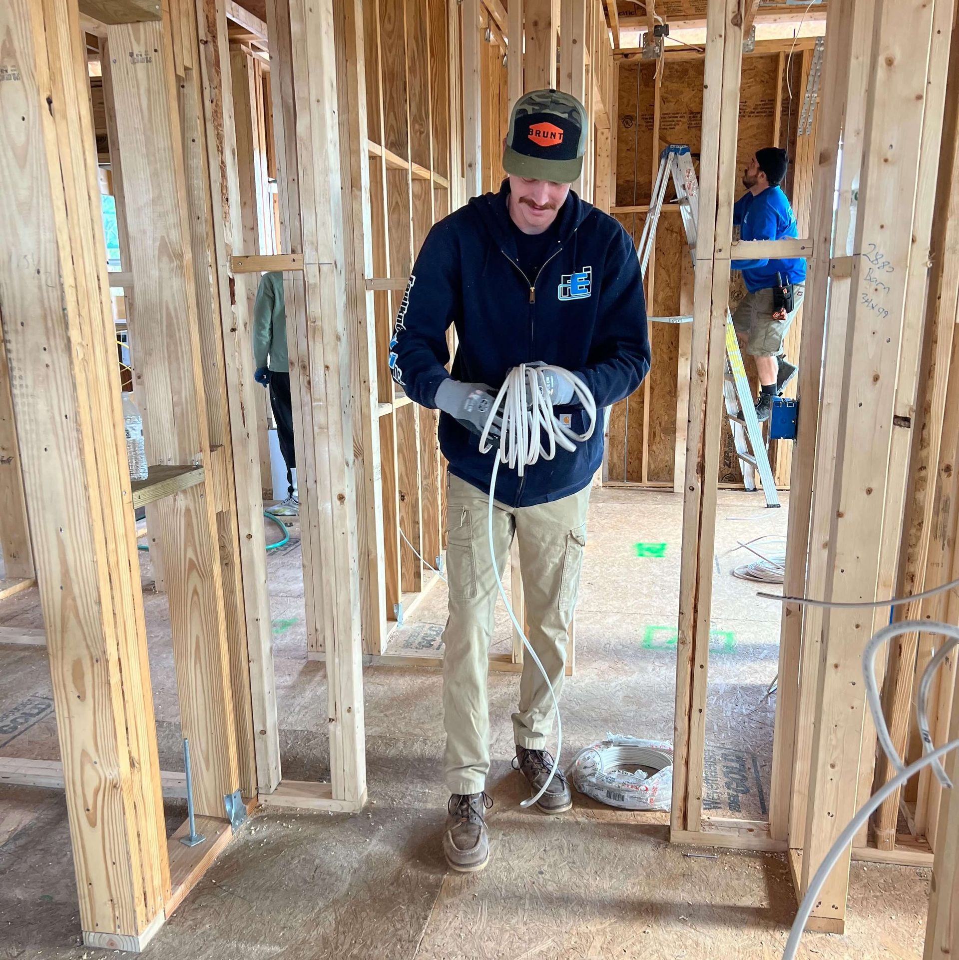 A man is holding a rope in a building under construction