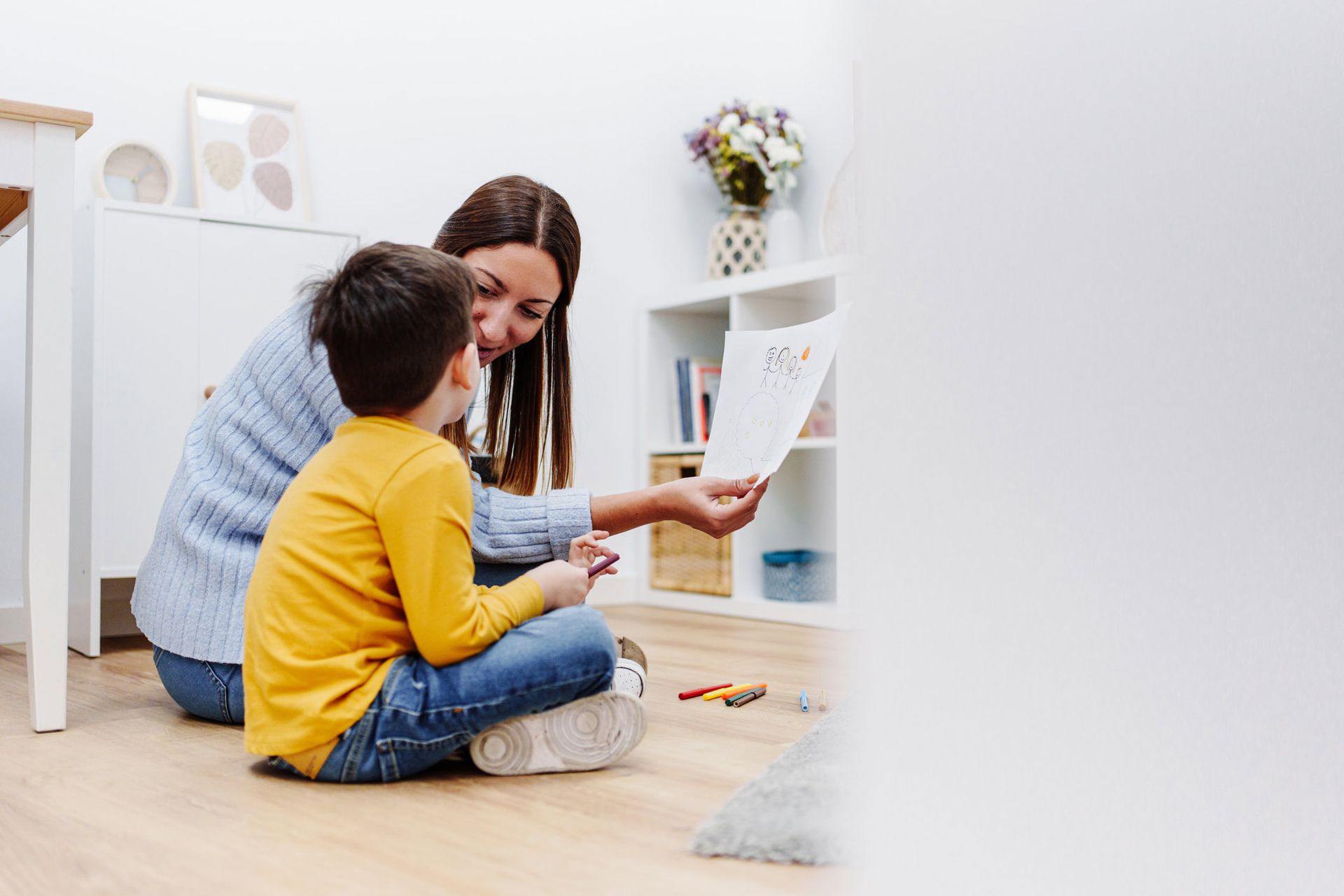 Professional Child Education Therapist Talking About Family With A Kid — Palm Beach Gardens, FL — ABA Growth Team