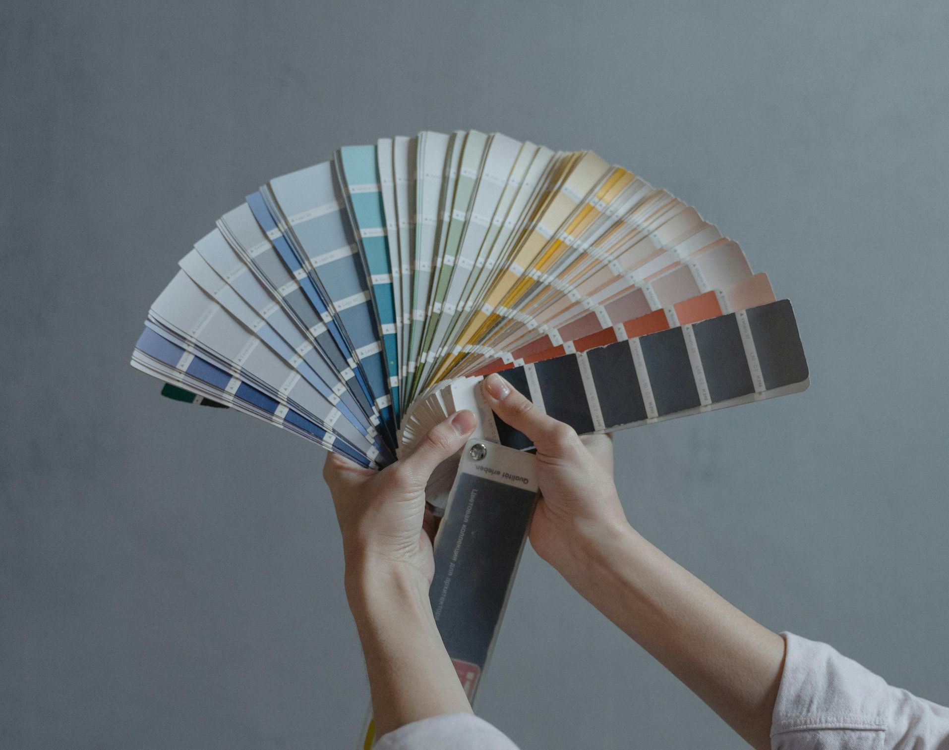 Professional painter in Seattle showcasing vibrant paint color samples for home interior design