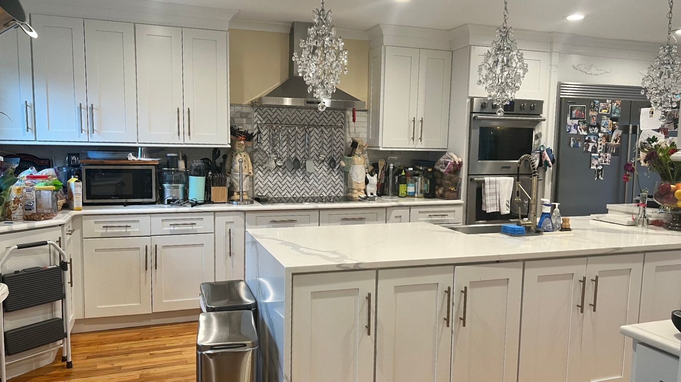 Amaya's Cleaning Service - A kitchen with white cabinets , stainless steel appliances , and a large island.