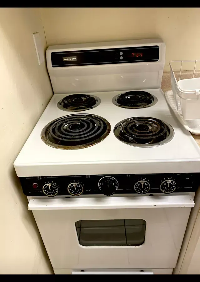 Amaya's Cleaning Service - A white electric stove with four burners and an oven