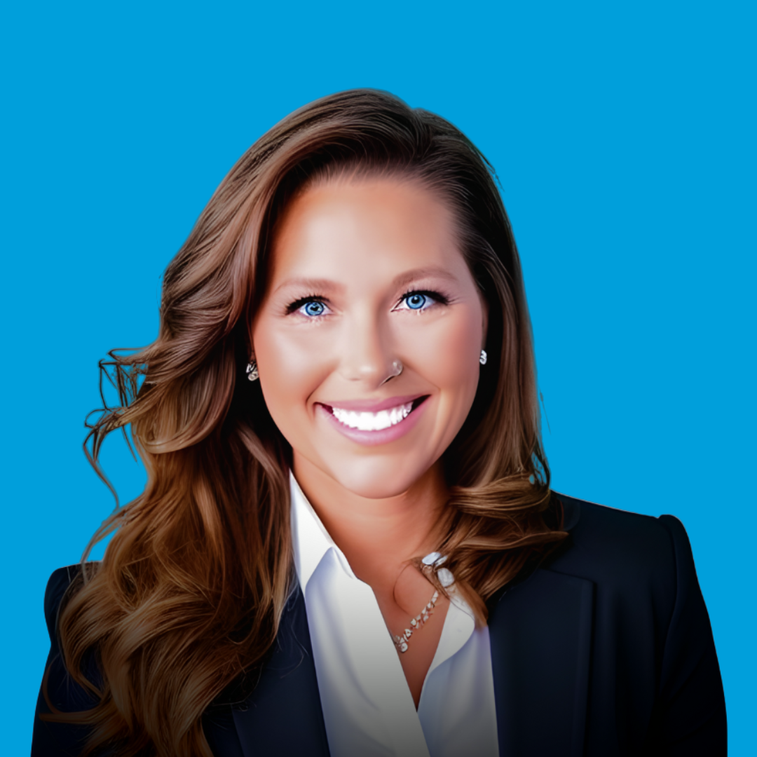 Woman in blazer smiles at the camera against a blue background.