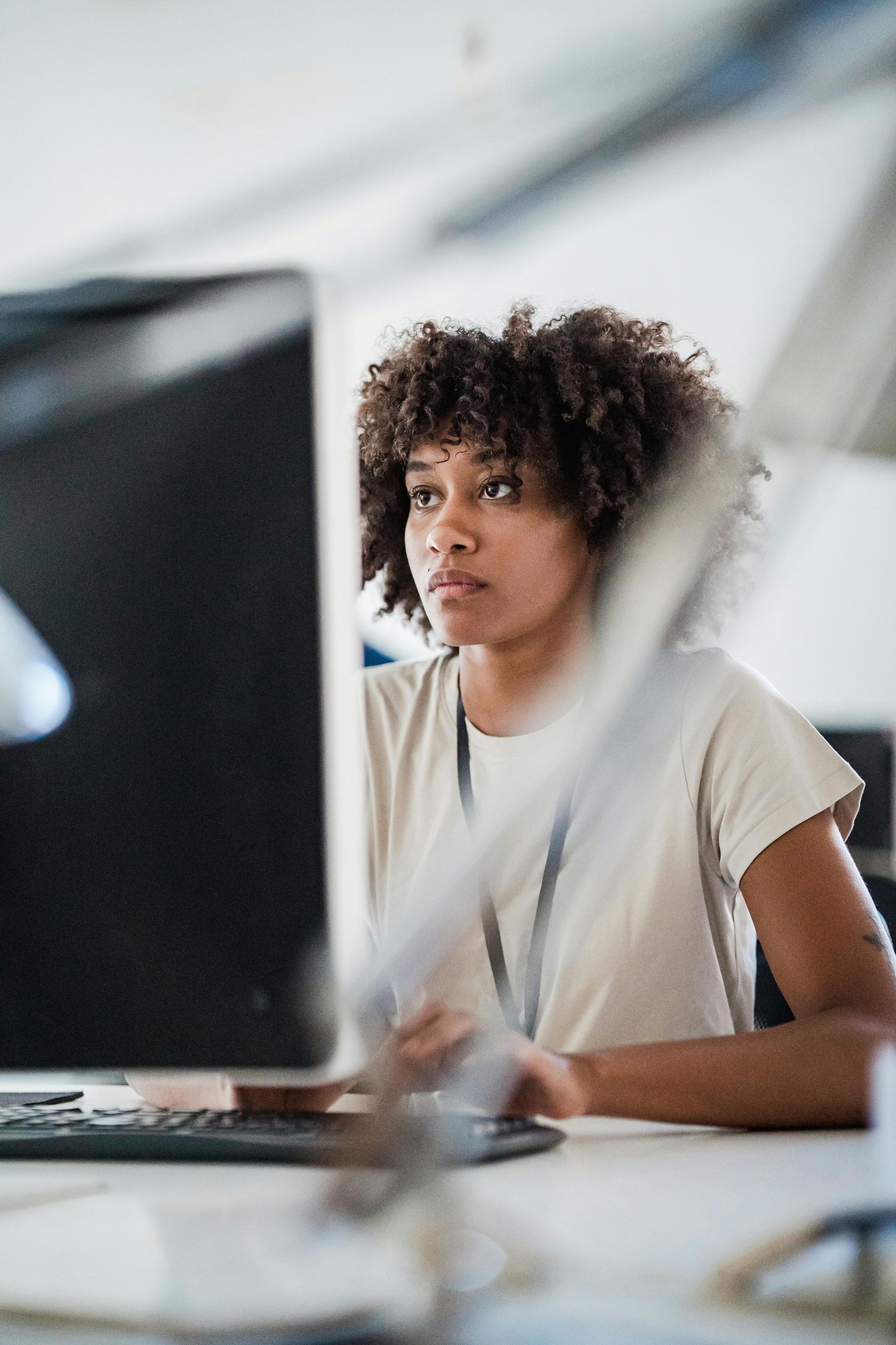 Person working at a desk with a computer in a bright office setting