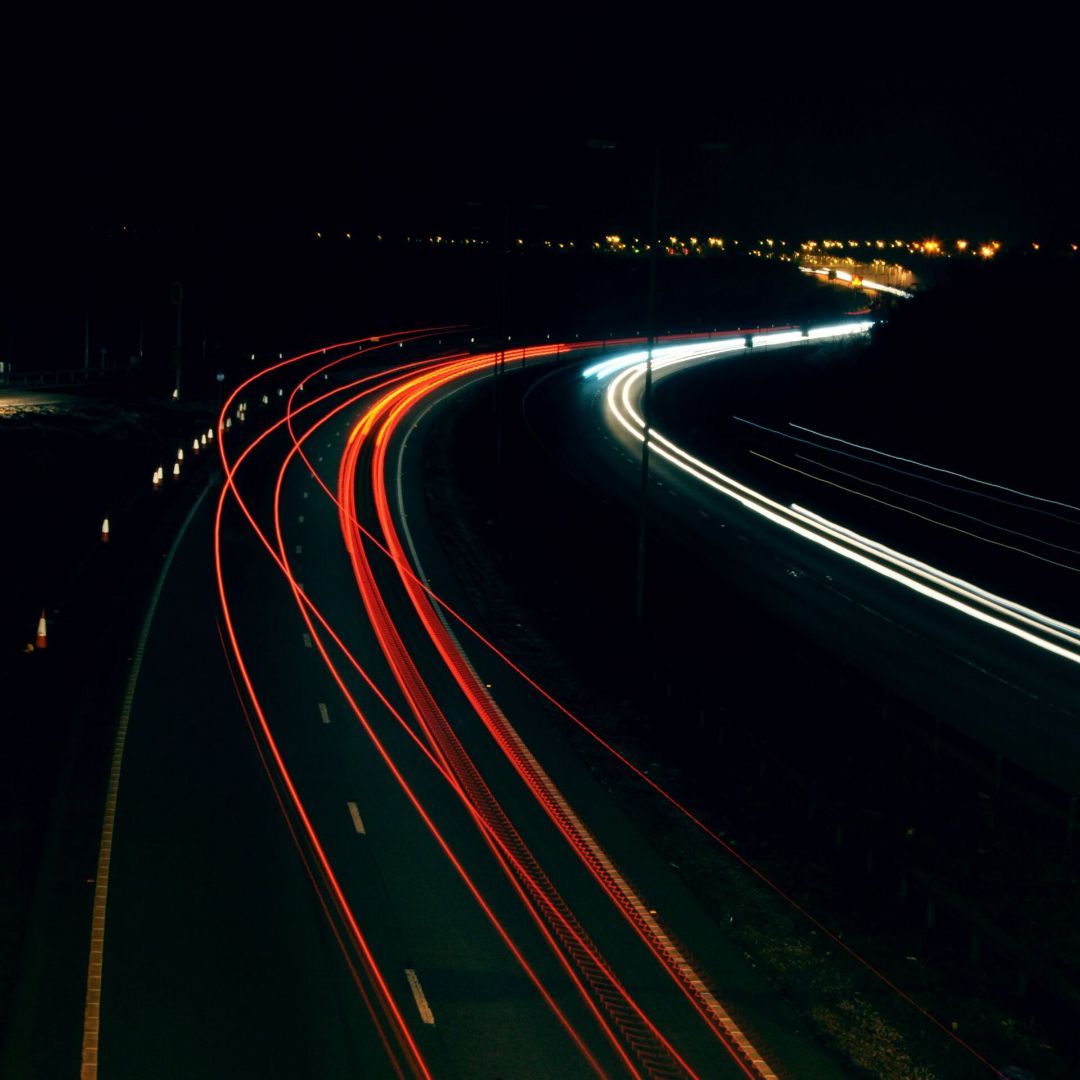 A long exposure photo of a highway at night