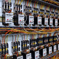 Rows of electrical relays and wiring inside a control panel cabinet