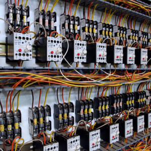 Rows of electrical relays and wiring inside a control panel cabinet