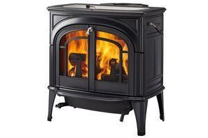 Black cast-iron wood stove with lit fire behind arched glass doors