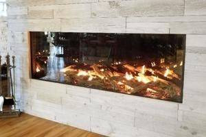 Modern wall-mounted fireplace with visible flames in a light stone surround, above a hardwood floor
