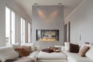 Bright modern living room with white sectional sofa and a sleek fireplace