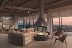 Modern living room with sectional sofa, fireplace, and floor-to-ceiling windows at sunset