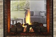 Modern fireplace with burning logs and flames, framed by a stone surround, with a sofa visible in the background