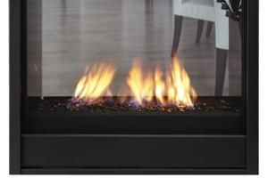 Modern black fireplace with bright flames behind glass panel