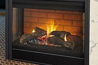 Lit fireplace with glowing flames and logs behind glass in a black frame