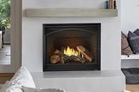 Modern living room fireplace with a black frame and visible flames, framed by a white mantel