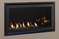 Modern black wall-mounted gas fireplace with yellow flames on a beige wall