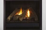 Lit gas fireplace with glowing flames behind dark ceramic logs