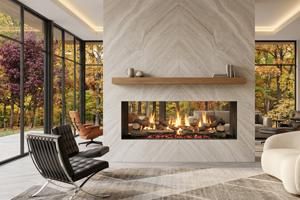 Modern living room with a long fireplace, large windows, and autumn trees outside