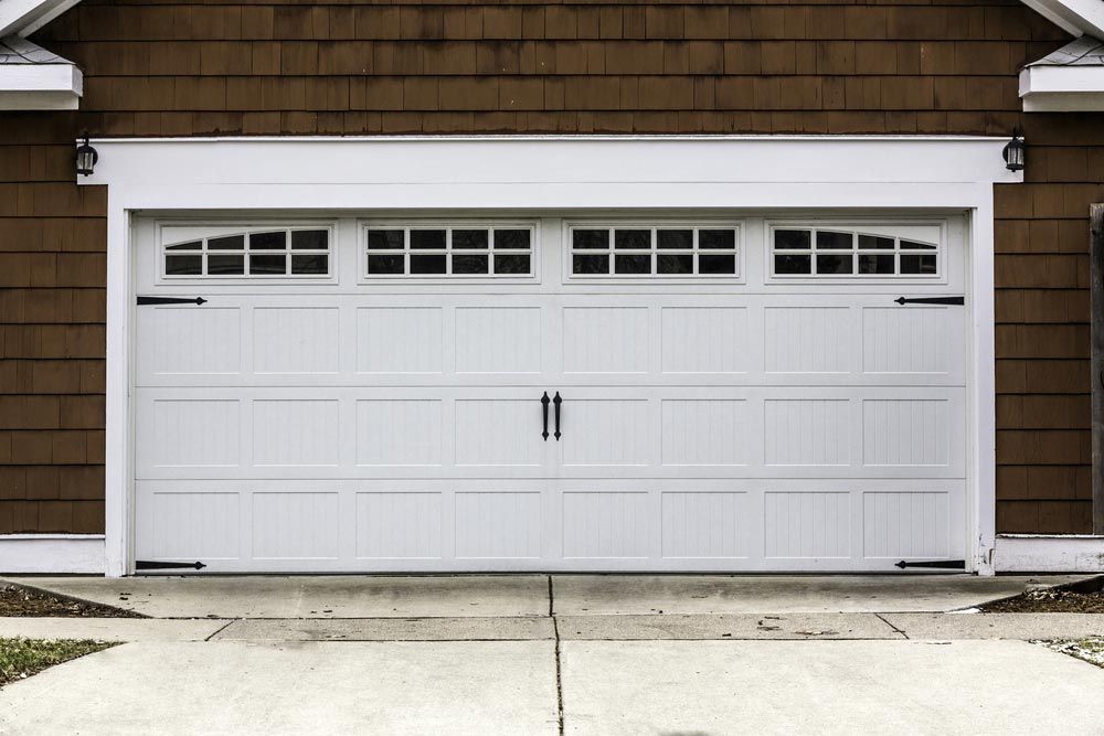 White Garage Door With Windows and Black Hardware — Axcess Garage Doors in Yeppoon, QLD