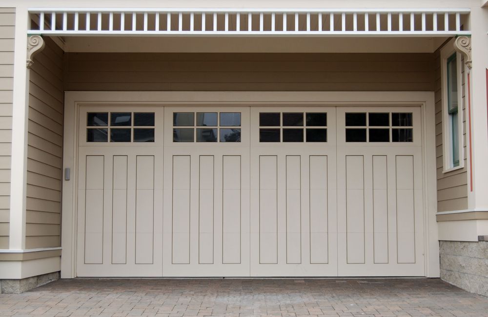 Beige Garage Door With Square Windows and Decorative Trim — Axcess Garage Doors in Yeppoon, QLD
