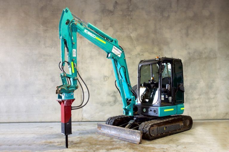 A blue and black excavator with a red hammer attached to it.