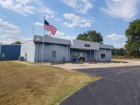 An american flag is flying in front of a building