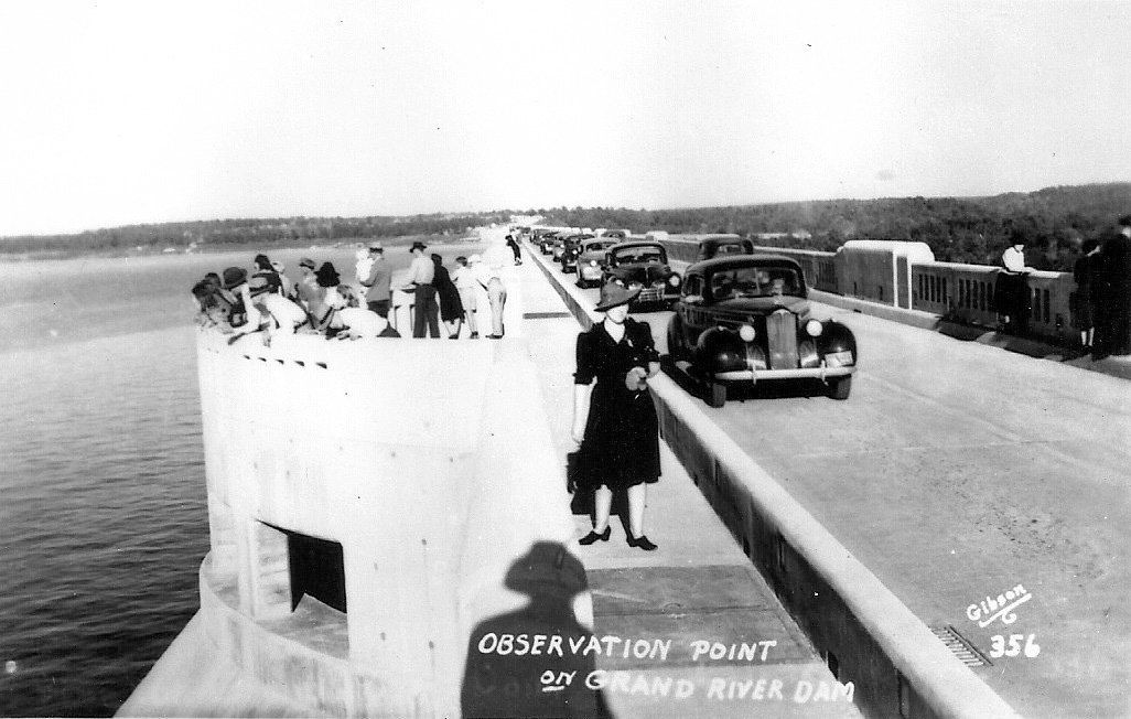 A black and white photo of a bridge over a body of water