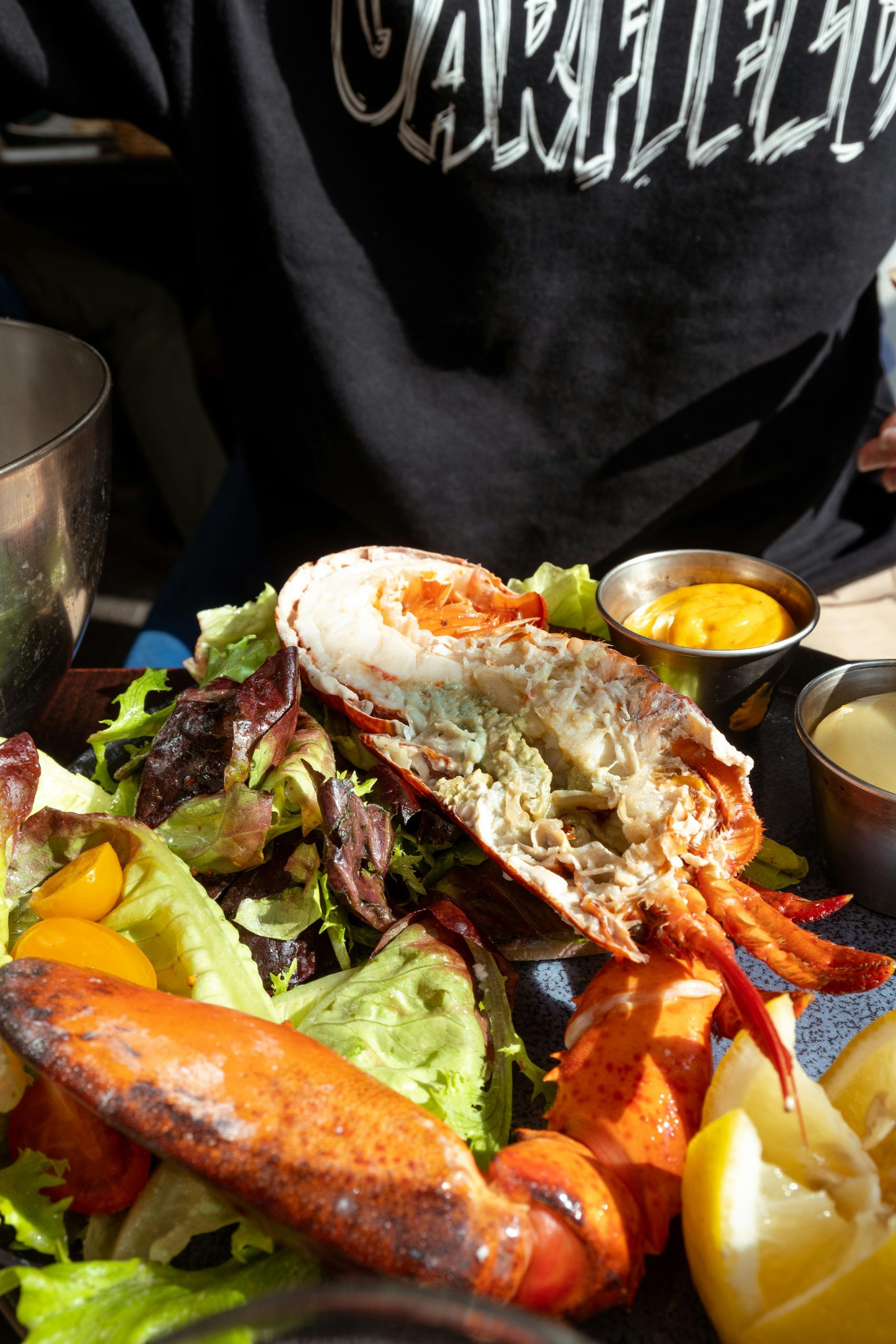 Lobster salad with side of sauces and lemon slices.