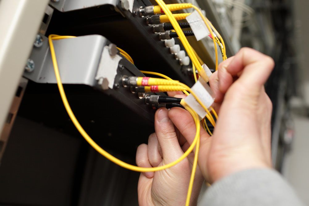 Technician fitting Fibre Optics— Country to Coast Cabling in Rockhampton, QLD