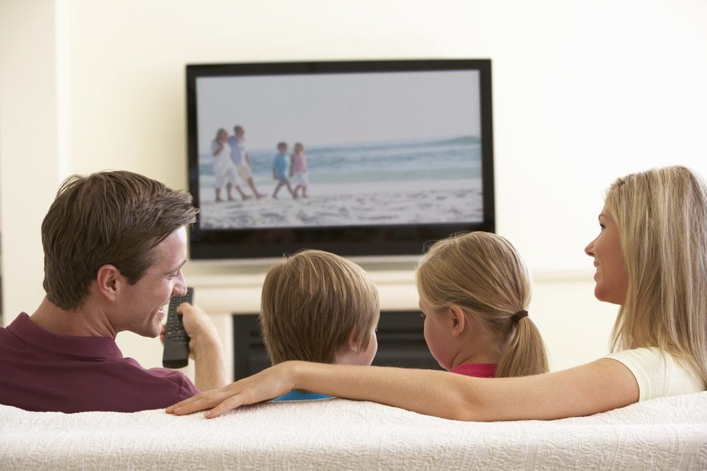 Family Watching TV— Country to Coast Cabling in Rockhampton, QLD