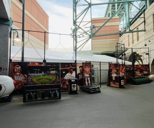 Display with signs and tent structure at a stadium. Featuring baseball-themed images and memorabilia.