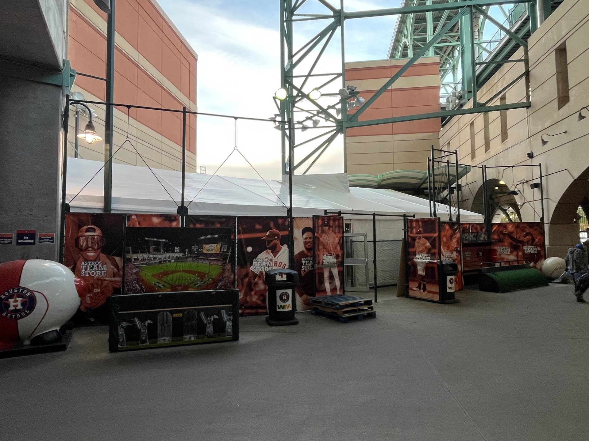 Outdoor display at a stadium, featuring Astros memorabilia, a white tent, and promotional materials.