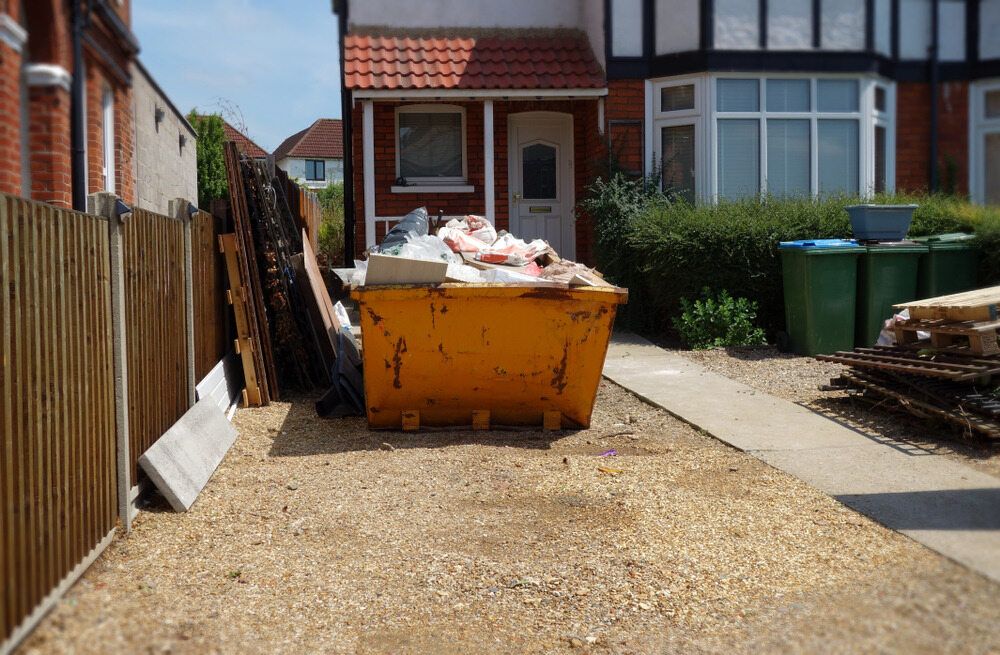 A yellow dumpster is sitting in front of a house — Eco Skips In Midge Point, QLD
