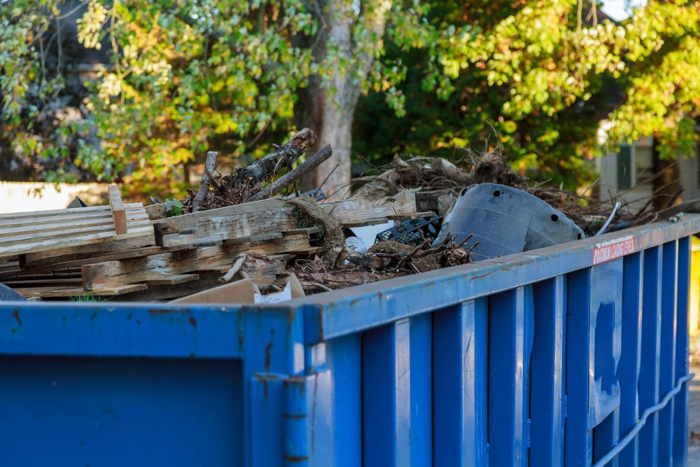 A Man Is Working On A Garbage Truck — Eco Skips In Midge Point, QLD